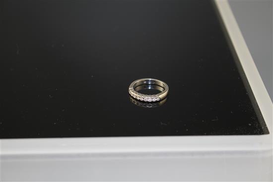 A modern 18ct white gold and ten stone diamond chip set half eternity ring, size M, gross weight 4.5 grams.